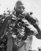 Dr Jagan wearing a mala made of dollar bills and flowers.