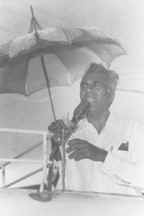 Dr. Jagan at the podium in the rain.
